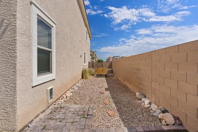 9305 Briar Bridge Ave, Las Vegas, NV 89148 - view of property exterior with stucco siding, a fenced backyard, and a patio