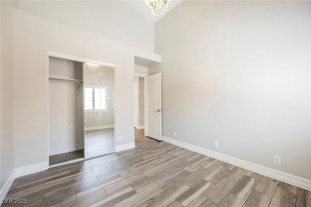 3882 Genoa Dr, Las Vegas, NV 89141 - unfurnished bedroom featuring a chandelier, wood finish floors, and a closet