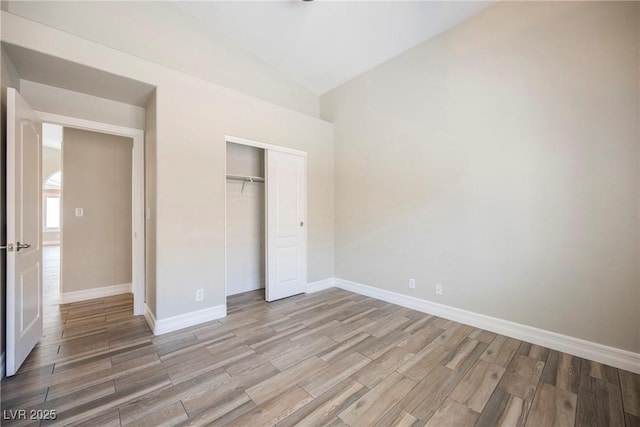 3882 Genoa Dr, Las Vegas, NV 89141 - unfurnished bedroom featuring wood finished floors, a closet, and high vaulted ceiling