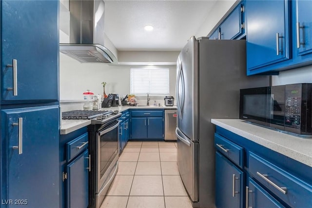 2690 Diamante Cir, Las Vegas, NV 89121 - kitchen featuring wall chimney exhaust hood, stainless steel appliances, blue cabinets, and light tile patterned floors