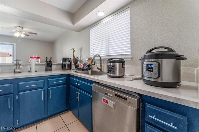 2690 Diamante Cir, Las Vegas, NV 89121 - kitchen featuring dishwasher, blue cabinetry, a ceiling fan, and light tile patterned floors