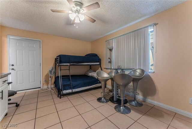 2690 Diamante Cir, Las Vegas, NV 89121 - bedroom with a textured ceiling, a ceiling fan, and light tile patterned floors