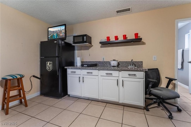 2690 Diamante Cir, Las Vegas, NV 89121 - kitchen featuring black appliances, white cabinets, open shelves, light tile patterned floors, and a textured ceiling