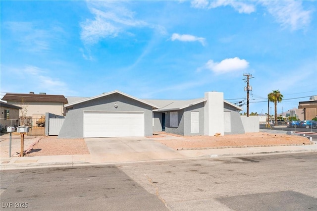 2690 Diamante Cir, Las Vegas, NV 89121 - view of front of home with an attached garage, concrete driveway, stucco siding, and a gate