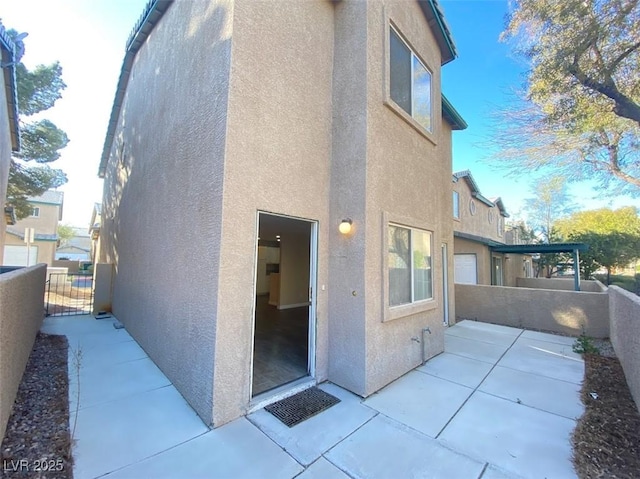 5266 Souvenir Ln, Las Vegas, NV 89118 - back of house with stucco siding, a patio area, and a gate