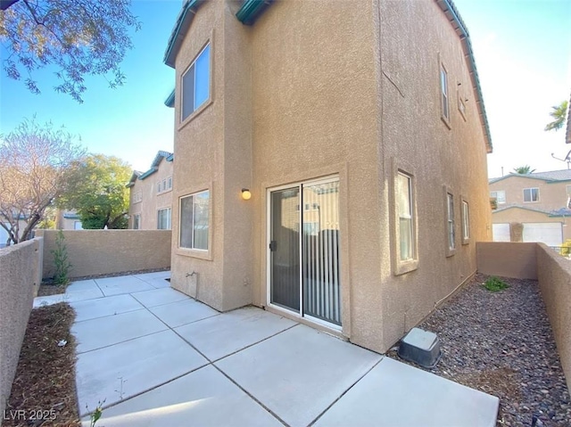 5266 Souvenir Ln, Las Vegas, NV 89118 - back of house featuring stucco siding, a patio area, and a fenced backyard
