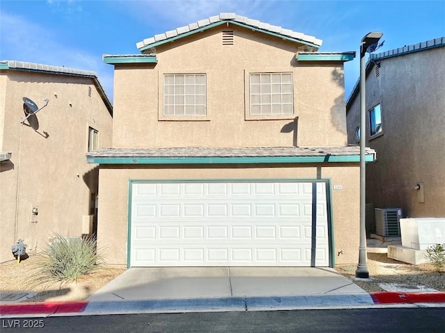 5266 Souvenir Ln, Las Vegas, NV 89118 - view of front of house with stucco siding, a garage, and concrete driveway