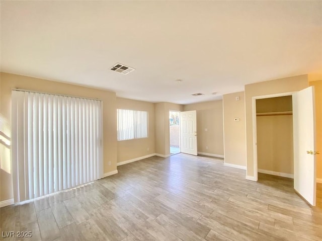 5266 Souvenir Ln, Las Vegas, NV 89118 - unfurnished living room with light wood-type flooring and baseboards
