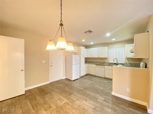 5266 Souvenir Ln, Las Vegas, NV 89118 - kitchen with white appliances, light wood-type flooring, recessed lighting, white cabinets, and pendant lighting