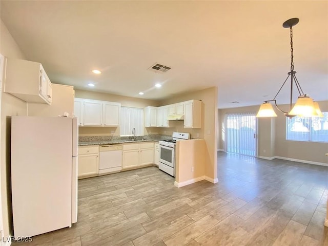 5266 Souvenir Ln, Las Vegas, NV 89118 - kitchen featuring white appliances, a chandelier, recessed lighting, light wood-style floors, and white cabinets