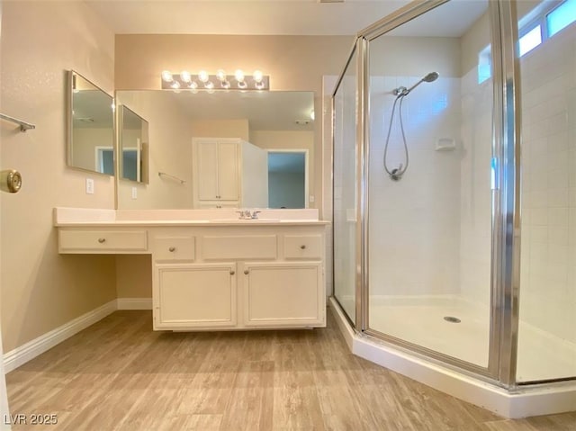 5266 Souvenir Ln, Las Vegas, NV 89118 - bathroom featuring a stall shower, wood finished floors, and vanity