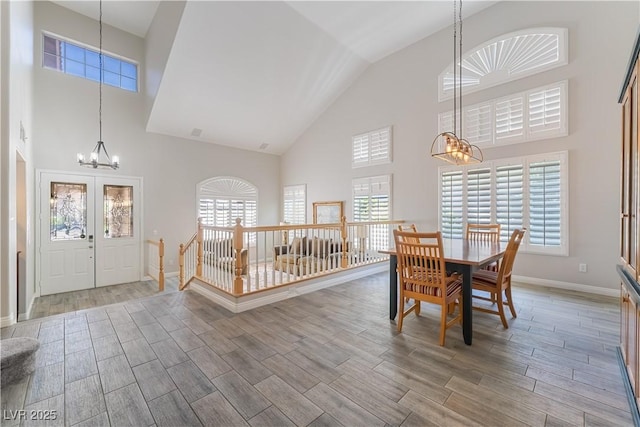 8424 Willowleaf Ct, Las Vegas, NV 89128 - dining room with a chandelier, high vaulted ceiling, and wood finished floors