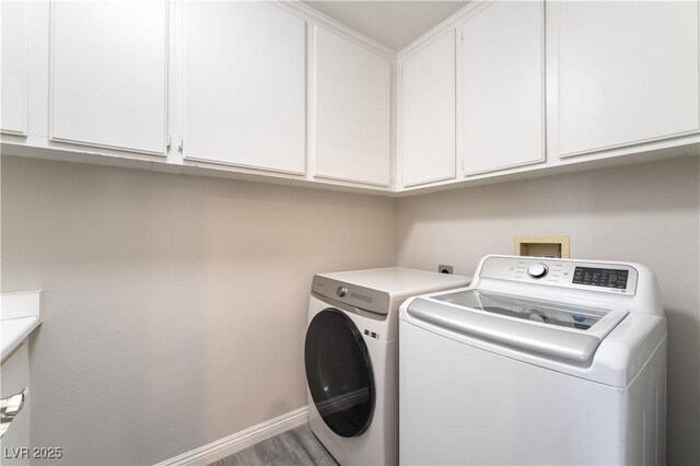 8424 Willowleaf Ct, Las Vegas, NV 89128 - laundry room with cabinet space, independent washer and dryer, and wood finished floors