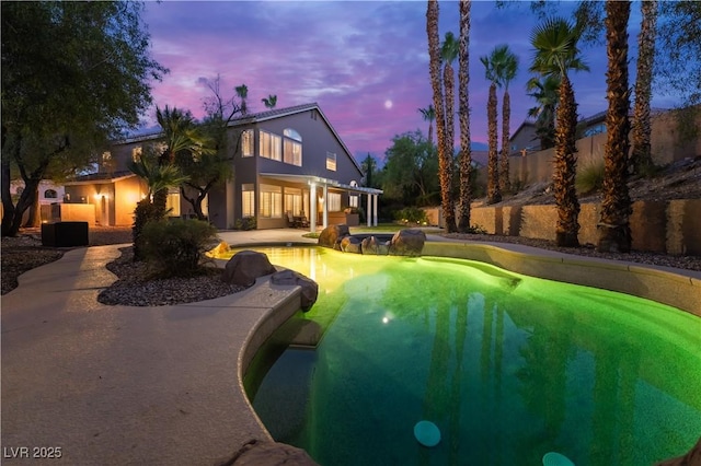 8424 Willowleaf Ct, Las Vegas, NV 89128 - pool at dusk with a patio area