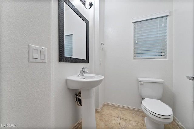 9217 Apollo Heights Ave, Las Vegas, NV 89149 - half bath featuring toilet and tile patterned flooring