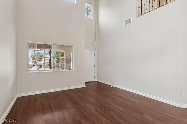 5541 Meridian Rain St, North Las Vegas, NV 89031 - unfurnished room with a towering ceiling, dark wood-type flooring, and plenty of natural light