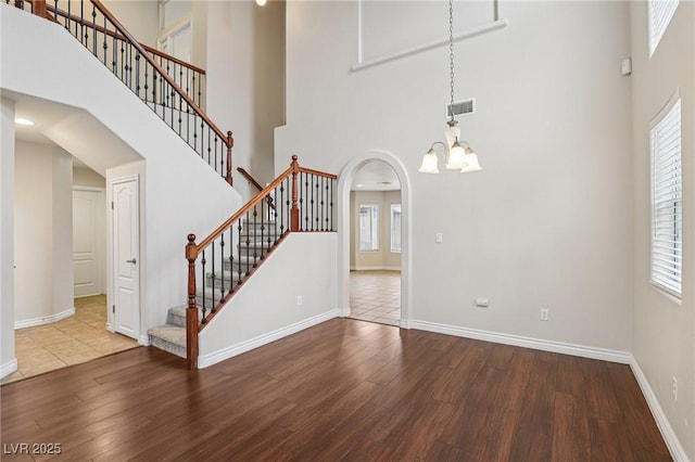 5541 Meridian Rain St, North Las Vegas, NV 89031 - unfurnished living room featuring a high ceiling, wood finished floors, and plenty of natural light