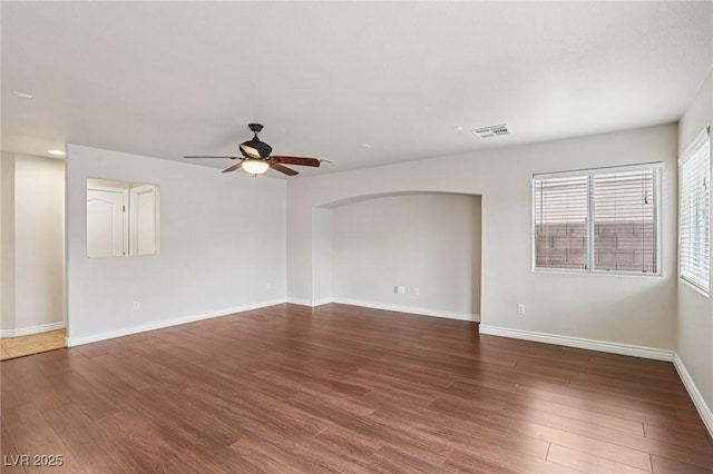 5541 Meridian Rain St, North Las Vegas, NV 89031 - spare room featuring ceiling fan, arched walkways, and wood finished floors