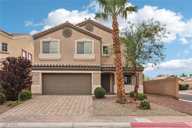 5541 Meridian Rain St, North Las Vegas, NV 89031 - view of front of house featuring decorative driveway, stucco siding, a garage, and a tile roof
