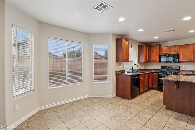 5541 Meridian Rain St, North Las Vegas, NV 89031 - kitchen with black appliances, recessed lighting, dark stone countertops, light tile patterned floors, and arched walkways