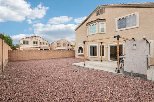 5541 Meridian Rain St, North Las Vegas, NV 89031 - back of property featuring stucco siding, a fenced backyard, a patio area, and a pergola