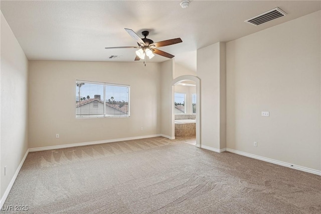 5541 Meridian Rain St, North Las Vegas, NV 89031 - carpeted spare room featuring arched walkways, ceiling fan, vaulted ceiling, and a smoke detector
