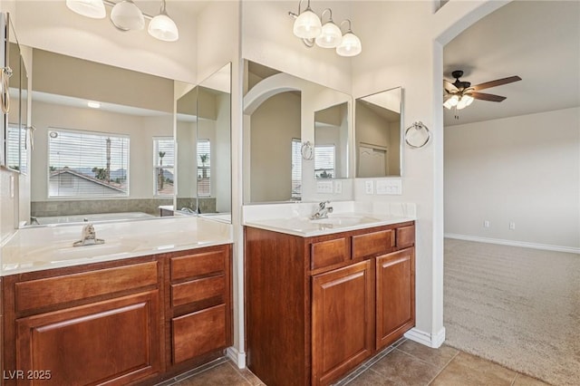 5541 Meridian Rain St, North Las Vegas, NV 89031 - bathroom featuring a ceiling fan, vanity, tile patterned flooring, and a tub to relax in