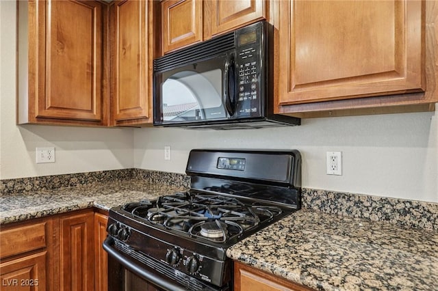 5541 Meridian Rain St, North Las Vegas, NV 89031 - kitchen with black appliances, brown cabinetry, and dark stone countertops
