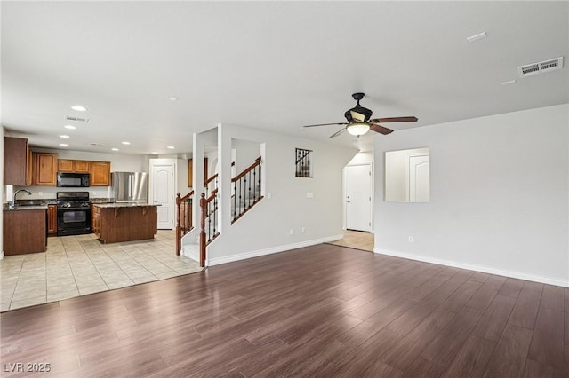 5541 Meridian Rain St, North Las Vegas, NV 89031 - unfurnished living room featuring recessed lighting, ceiling fan, light wood-style flooring, and stairs