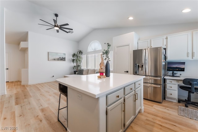 7909 Lovely Pine Pl, Las Vegas, NV 89143 - kitchen featuring stainless steel fridge, a ceiling fan, lofted ceiling, a desk, and light wood-style flooring