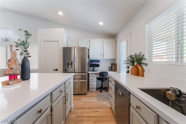 7909 Lovely Pine Pl, Las Vegas, NV 89143 - kitchen with stainless steel fridge with ice dispenser, dishwasher, vaulted ceiling, built in study area, and light wood-style floors