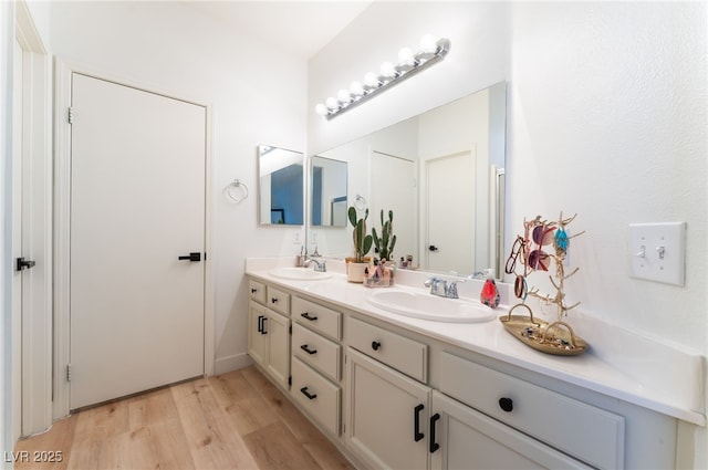 7909 Lovely Pine Pl, Las Vegas, NV 89143 - bathroom featuring double vanity and wood finished floors
