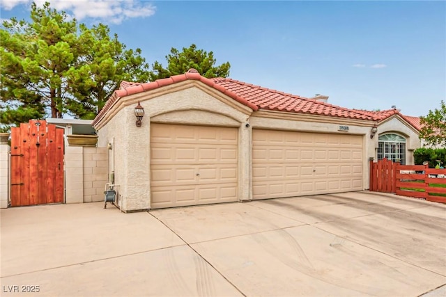 3938 Redfield Ave, North Las Vegas, NV 89032 - view of front of property featuring concrete driveway, a gate, a tiled roof, and stucco siding