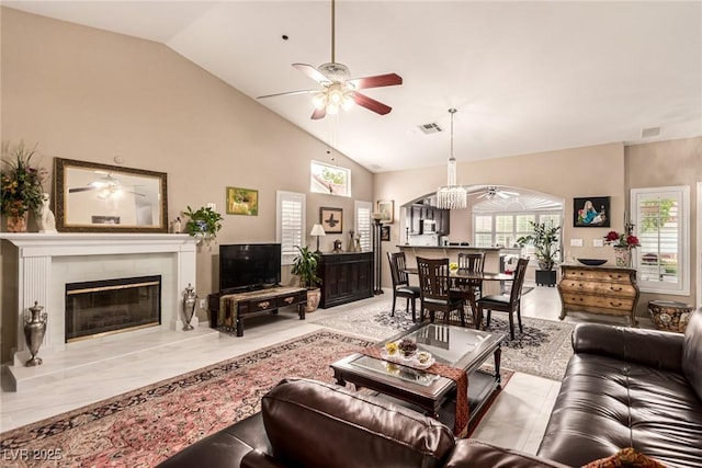 3938 Redfield Ave, North Las Vegas, NV 89032 - living area with a ceiling fan, arched walkways, a fireplace, and high vaulted ceiling