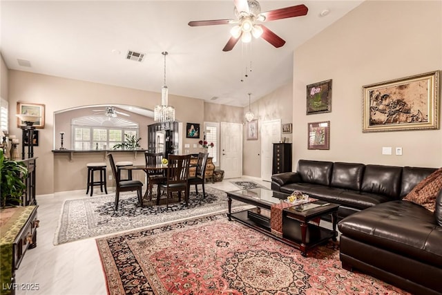 3938 Redfield Ave, North Las Vegas, NV 89032 - living room with a ceiling fan, arched walkways, a chandelier, and high vaulted ceiling