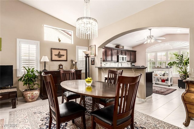 3938 Redfield Ave, North Las Vegas, NV 89032 - dining space featuring vaulted ceiling, arched walkways, ceiling fan, and a chandelier