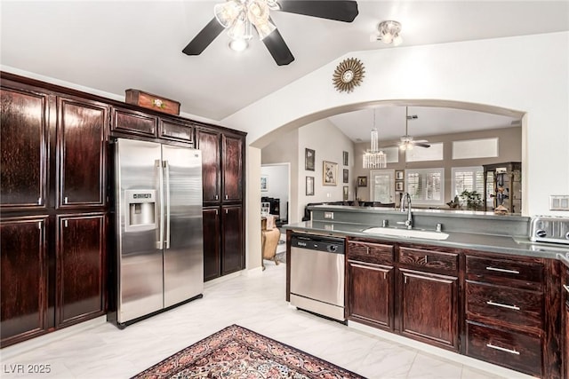 3938 Redfield Ave, North Las Vegas, NV 89032 - kitchen featuring stainless steel appliances, a ceiling fan, vaulted ceiling, arched walkways, and dark countertops