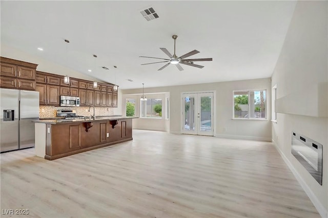 6125 Resort Ridge St, Las Vegas, NV 89130 - kitchen with appliances with stainless steel finishes, vaulted ceiling, ceiling fan, light wood-type flooring, and open floor plan