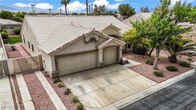 6125 Resort Ridge St, Las Vegas, NV 89130 - view of front of house featuring stucco siding, a tile roof, concrete driveway, a garage, and a gate