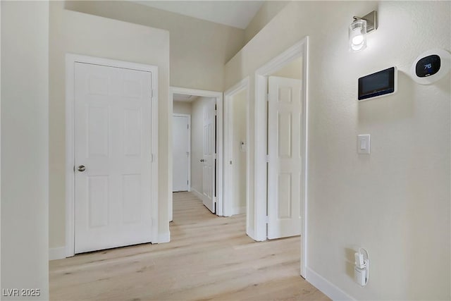 6125 Resort Ridge St, Las Vegas, NV 89130 - hallway featuring light wood-style floors and baseboards