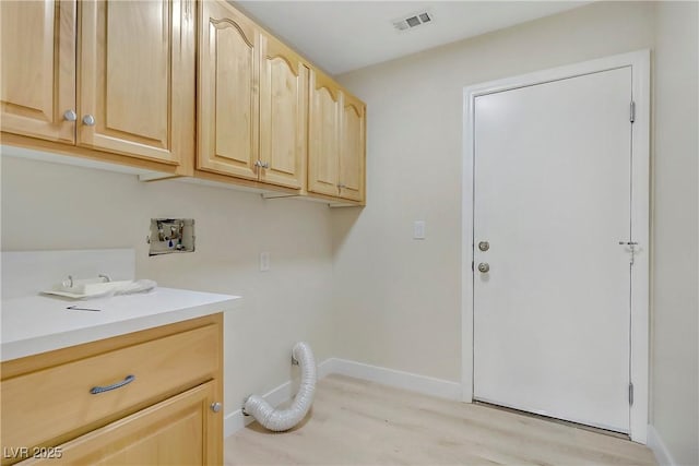 6125 Resort Ridge St, Las Vegas, NV 89130 - washroom featuring cabinet space, washer hookup, and light wood-style floors