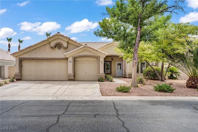 6125 Resort Ridge St, Las Vegas, NV 89130 - view of front of property featuring an attached garage, driveway, stucco siding, and a tiled roof