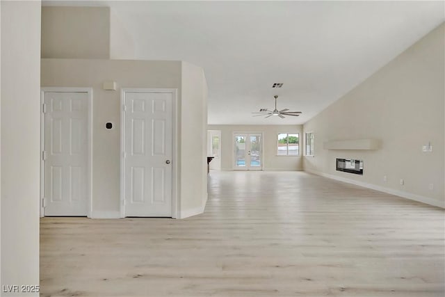 6125 Resort Ridge St, Las Vegas, NV 89130 - unfurnished living room with light wood-type flooring, ceiling fan, and vaulted ceiling