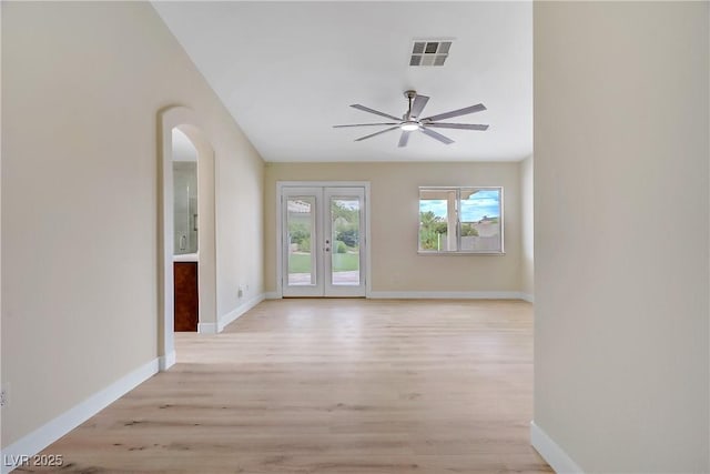 6125 Resort Ridge St, Las Vegas, NV 89130 - unfurnished room featuring light wood-style floors, a ceiling fan, arched walkways, and french doors