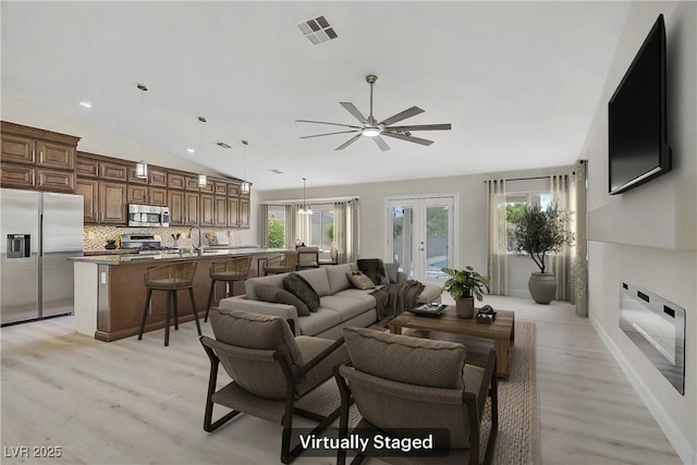 6125 Resort Ridge St, Las Vegas, NV 89130 - living room with lofted ceiling, light wood-style floors, plenty of natural light, ceiling fan, and french doors
