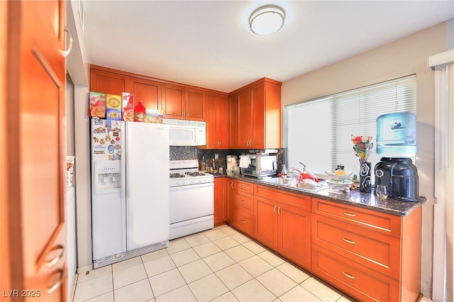 1500 Hialeah Dr Unit C, Las Vegas, NV 89119 - kitchen with white appliances, decorative backsplash, light tile patterned flooring, and brown cabinets