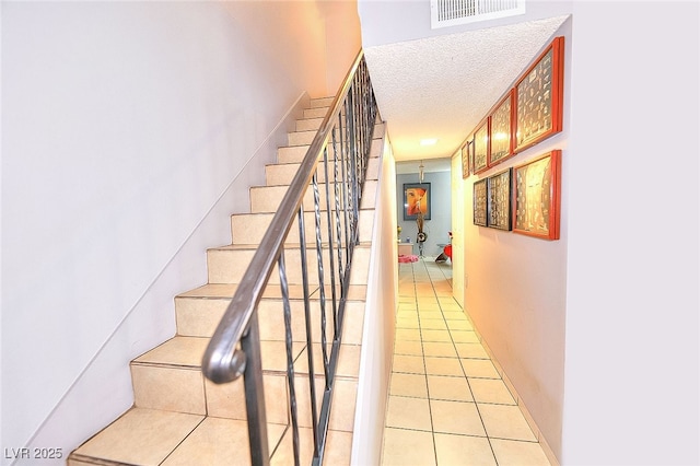 1500 Hialeah Dr Unit C, Las Vegas, NV 89119 - stairway featuring tile patterned floors and a textured ceiling