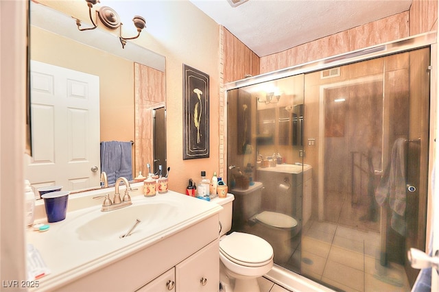 1500 Hialeah Dr Unit C, Las Vegas, NV 89119 - bathroom with a shower stall, vanity, a textured ceiling, and tile patterned flooring