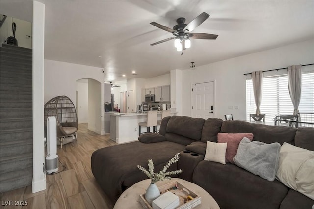 6388 Extreme Shear Ave Unit 103, Henderson, NV 89011 - living area featuring a ceiling fan, arched walkways, and light wood-style flooring