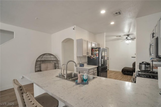 6388 Extreme Shear Ave Unit 103, Henderson, NV 89011 - kitchen featuring appliances with stainless steel finishes, ceiling fan, light wood-style floors, a peninsula, and recessed lighting